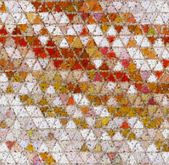 Fototapeta na wymiar orange and beige triangle mosaic with similar but different tiles