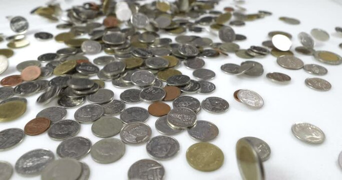 Coins falling on the white background. Slow motion 
