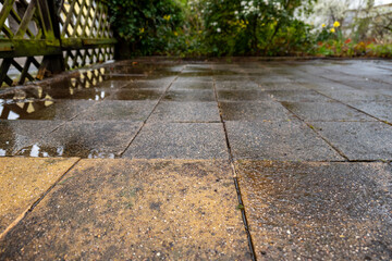 wet old paving slabs in a house driveway
