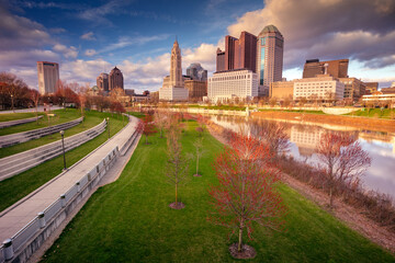 Columbus, Ohio, USA. Cityscape image of Columbus , Ohio, USA downtown skyline with reflection of the city in the Scioto River at spring sunset.