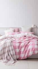 A cozy pink and white gingham bedding set on a bed with a white background