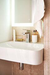 Bathroom sink with toothbrushes and running water.