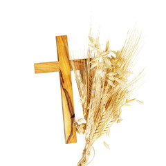 Isolated wooden crucifixion with bouquet of wheat and rye on transparent background. Religion card...