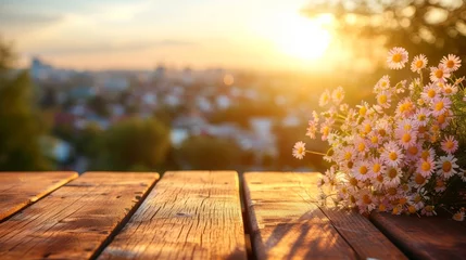 Draagtas Wooden table with a bouquet of daisies against the background of the setting sun © Adobe Contributor