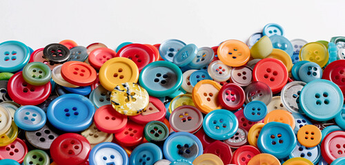 Fototapeta na wymiar Assorted colorful buttons in a pile, isolated on white background, blank label.