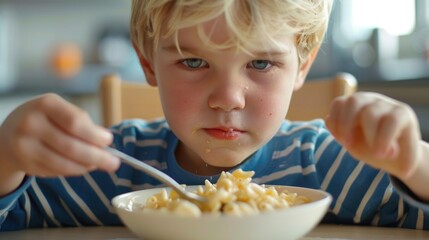 Young boy enjoying a bowl of cereal. Suitable for breakfast or nutrition concepts