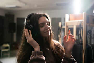 Smiling Woman Enjoying Music in a Professional Studio With Acoustic Foam Walls - 766503074