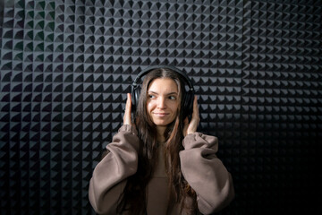 Smiling Woman Enjoying Music in a Professional Studio With Acoustic Foam Walls - 766503239