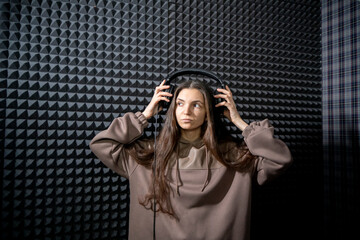 Smiling Woman Enjoying Music in a Professional Studio With Acoustic Foam Walls - 766503285