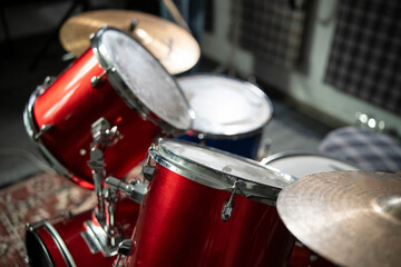 Close-Up View of a Red Acoustic Drum Set With Cymbals and Stool in a Music Studio - 766503622