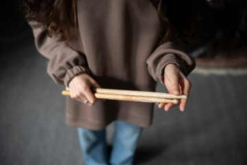 Drummer hands Holding Drumsticks While Standing in a Rehearsal Studio - 766503695