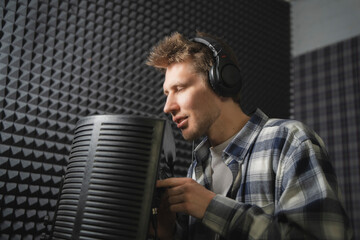 Aspiring Rapper Recording a New Track in a Soundproof Studio at Night - 766504088