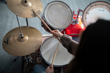 Drummers Hands Holding Sticks Mid-Performance on a Drum Set - 766505011