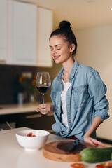 Pretty Females Enjoying a Relaxing Evening at Home, Tasting Wine in a Stylish Kitchen