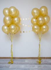 mother of pearl gold balloons with gold ribbons and a garland of gold stars