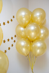 mother of pearl gold balloons with gold ribbons and a garland of gold stars