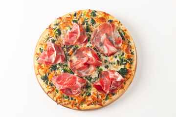 Pizza with prosciutto, ham, arugula, tomatoes, pesto, cheese and parmesan. Italian cuisine. 