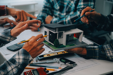 engineer people meeting working and pointing at a drawings in office for discussing. Engineering tools and construction concept.