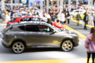 Blurred background of car show exposition.