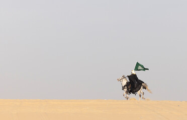 Saudi Man with his white stallion in a desert