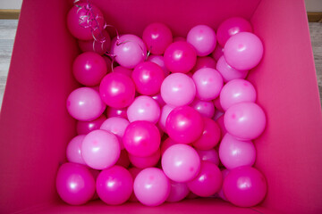 pink balloons in a large gift box