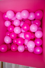 pink balloons in a large gift box