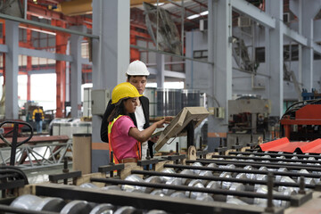Fototapeta na wymiar Manufacturing industrial concept. Male and female workers working at manufacturing production lines in factory during manufacturing process