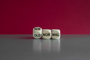 Old and new normal symbol. Turned a wooden cube and changes the expression old normal to new...