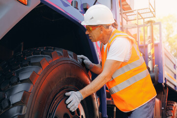 Repair of Industrial truck. Industry driver in hard hat checks breakdowns of lorry