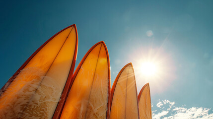 Photo of surfboard tops against blue sky. Summer holiday concept at sea