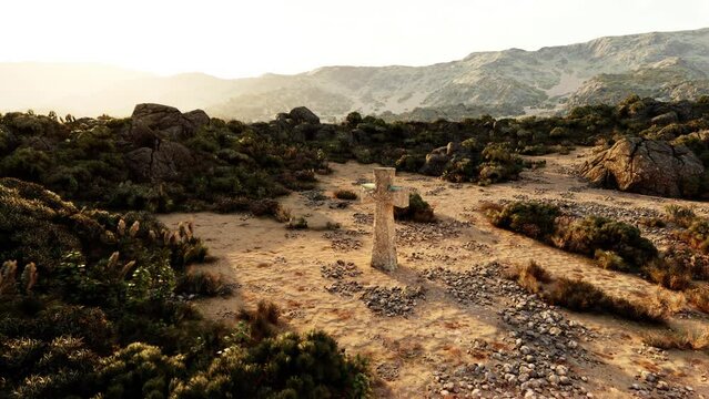A stone cross in the middle of a desert