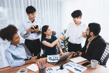 Diverse coworkers celebrate success with handshake and teamwork in corporate workplace....