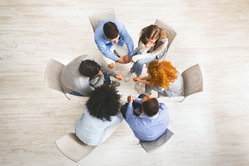 Group of people sitting in circle, dicussing problems during therapy session - obrazy, fototapety, plakaty