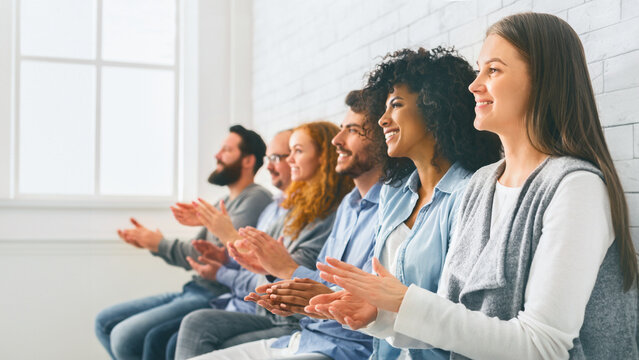 Happy People Sitting In Row Applauding To Mentor At Group Therapy