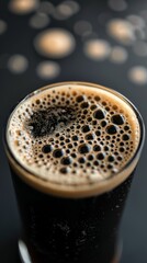 Close-up of black coffee bubbles, macro photography. Dark beverage texture concept for design and print with copy space