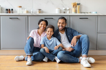 Portrait of loving african american family posing at kitchen