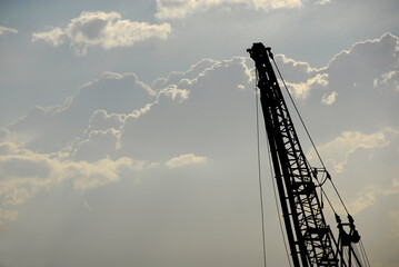 Port crane silhouette wih clouds - 766544419