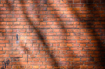 Large full frame background of detailed old red brick wall with shadow with copy space 1