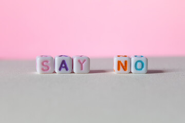 Colourful plastic letter cubes with the words say yes on gradient background concept