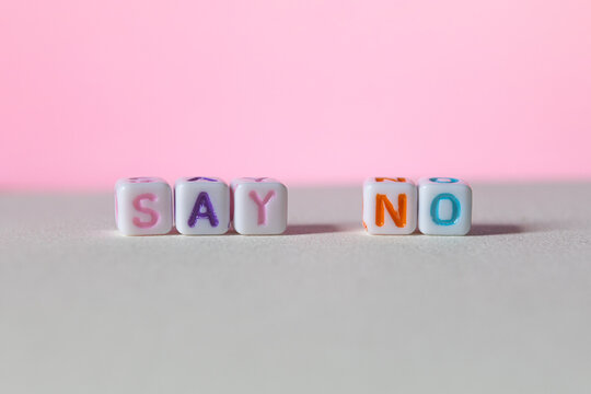 Colourful plastic letter cubes with the words say yes on gradient background concept