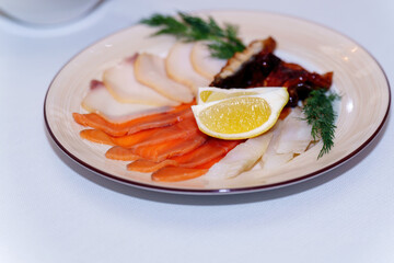Plate with various types of salted fish and lemon