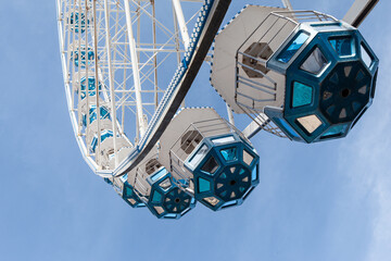 The pods of the Ferris wheel fly in the sky - 766548082
