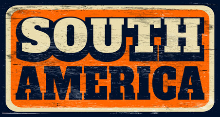 Aged and worn South America sign on wood