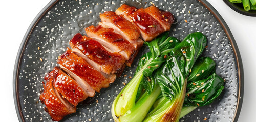 Jinan roasted duck, its crispy, reddish-brown skin beside vibrant green bok choy, on a charcoal gray plate, isolated on white background - obrazy, fototapety, plakaty