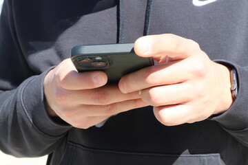 Digital Connection: Hands Engaged with Smartphone