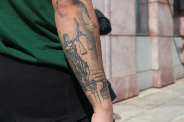 Symbolic Ink: Tattooed Arm Featuring Lady of Justice