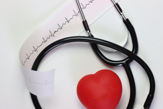 Ecg paper with trace with stethoscope and a red heart in a white background 