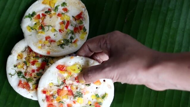Serving colorful South Indian Uttapam with Coconut, green chili chutney
