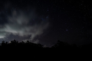 View of stars and clouds at Savinia beach located on the south coast of Mauritius island
