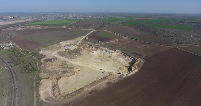 Aerial view of Sand quarry among plowed farm fields